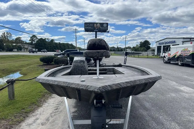 Slide: The Image of 2026 Xpress XP200 boat on trailer, outdoor showroom, cloudy sky background. - 7