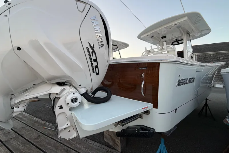 Slide: The Image of 2025 Regulator 31 boat with Yamaha XTO Offshore engine, docked on a wooden platform. - 16