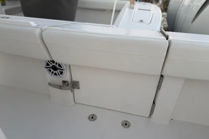 Slide: The Image of 2025 Regulator 31 boat interior with white cushioned seating and speaker detail. - 24