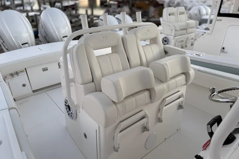 Slide: The Image of 2025 Regulator 31 boat interior with plush white seating and modern helm controls. - 25