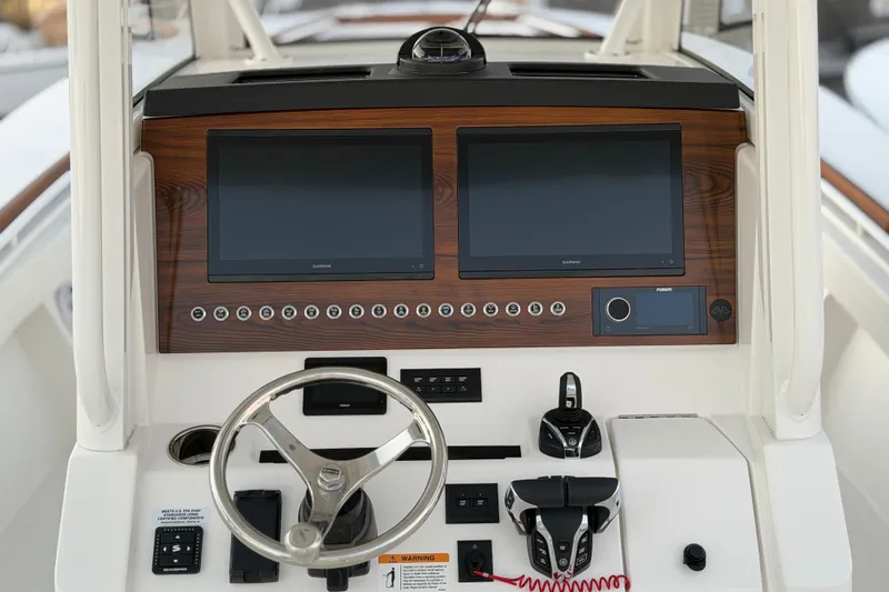 Slide: The Image of 2025 Regulator 31 boat dashboard with dual screens and modern controls. - 27