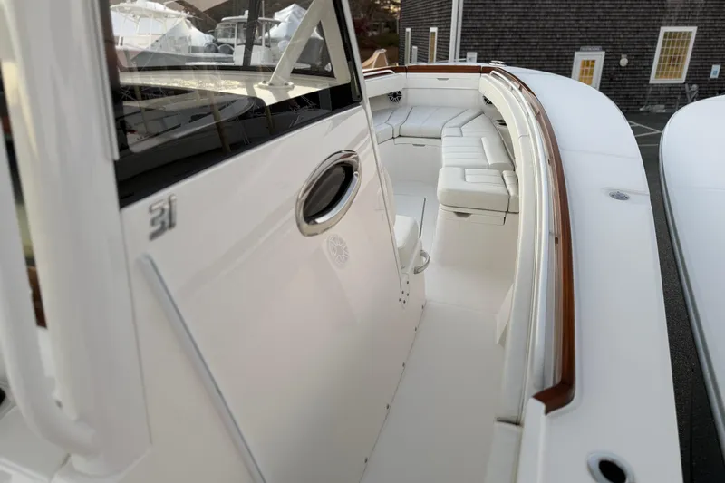 Slide: The Image of 2025 Regulator 31 boat interior with white seating and sleek design. - 29