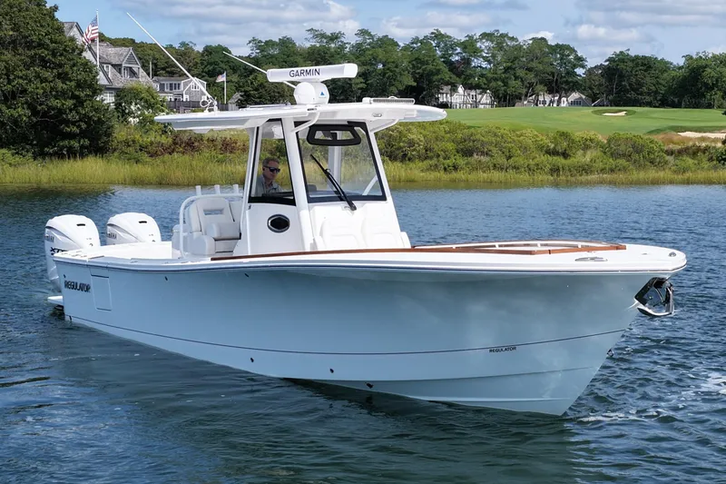 Slide: The Image of 2025 Regulator 31 boat on water, featuring dual engines and sleek design. - 3