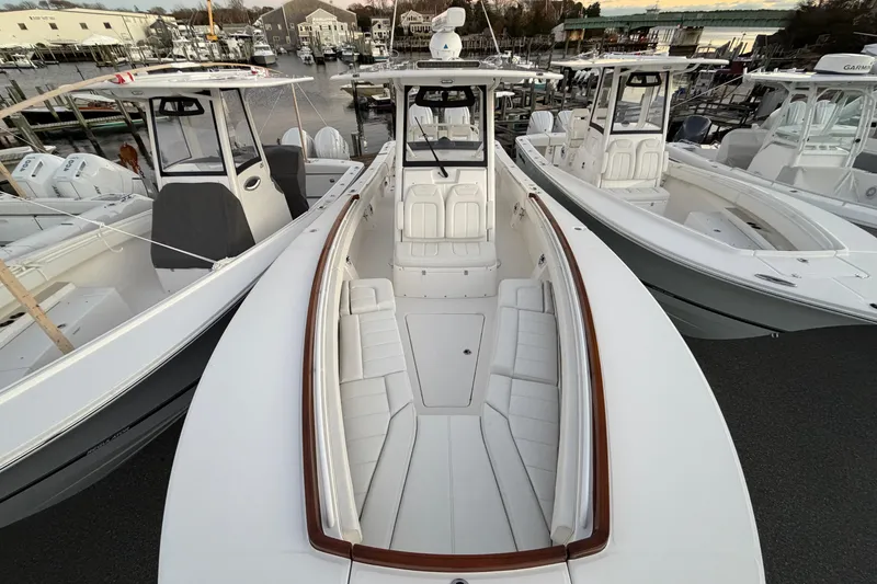 Slide: The Image of 2025 Regulator 31 boat docked, showcasing sleek design and spacious seating. - 32