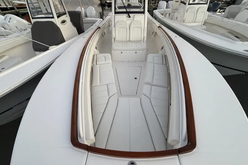 Slide: The Image of 2025 Regulator 31 boat interior with white seating and wooden trim. - 33