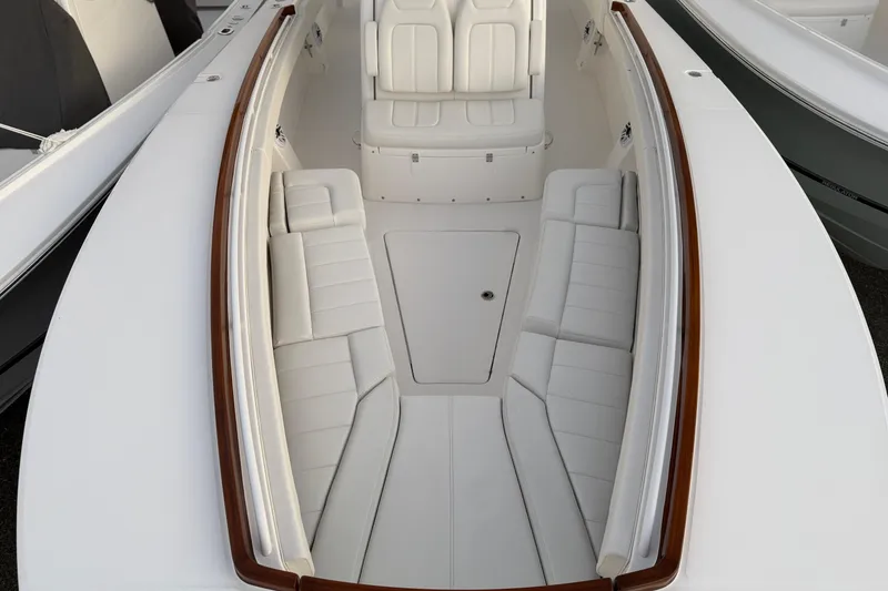 Slide: The Image of 2025 Regulator 31 boat interior with white cushioned seating and sleek design. - 34