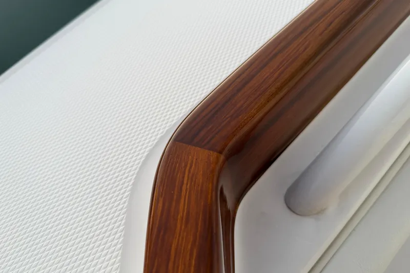 Slide: The Image of Close-up of 2025 Regulator 31 boat's textured surface and polished wood detail. - 37