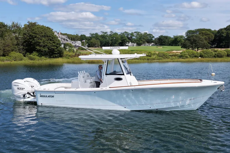 Slide: The Image of 2025 Regulator 31 boat on calm water, featuring Yamaha engines and Garmin equipment. - 4