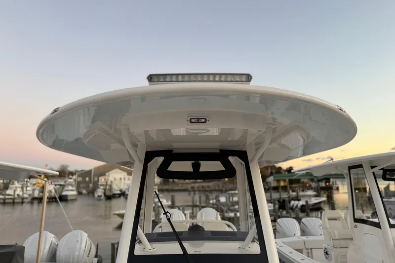 Slide: The Image of 2025 Regulator 31 boat with sleek T-top design at marina during sunset. - 40