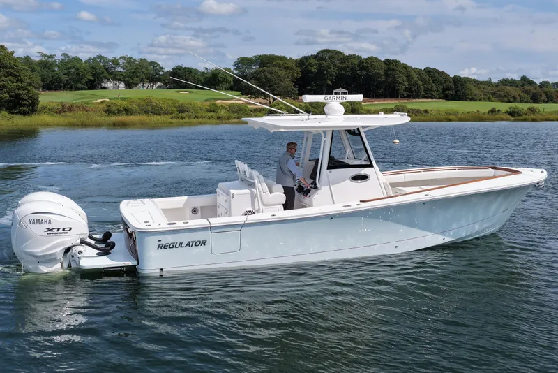 Slide: The Image of 2025 Regulator 31 boat on water, featuring Yamaha XTO engine, scenic background. - 5