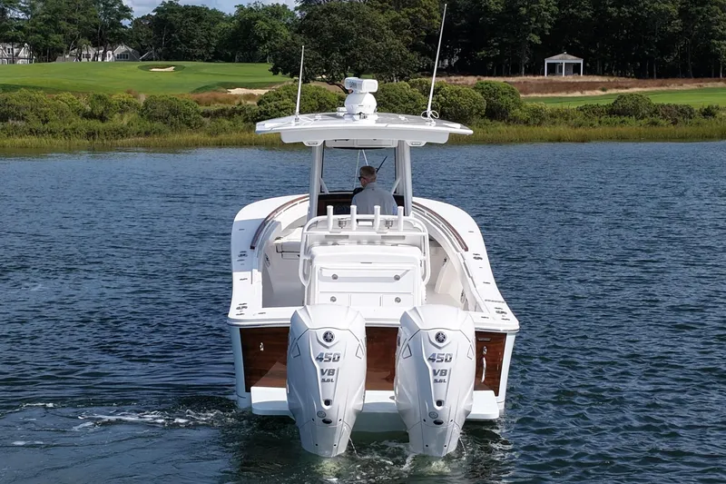 Slide: The Image of 2025 Regulator 31 boat with dual 450 V8 engines on a serene waterway. - 7