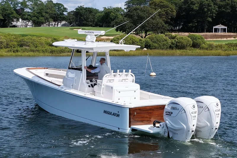 Slide: The Image of 2025 Regulator 31 boat with dual Yamaha engines on a scenic waterway. - 8