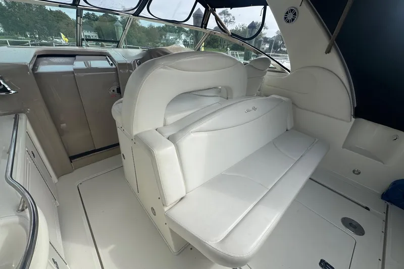 Slide: The Image of Interior of 2001 Sea Ray 410 Sundancer yacht with white seating and helm. - 14