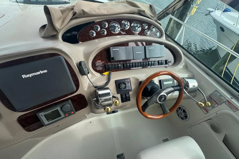 Slide: The Image of Cockpit of 2001 Sea Ray 410 Sundancer with Raymarine navigation system and wooden steering wheel. - 16