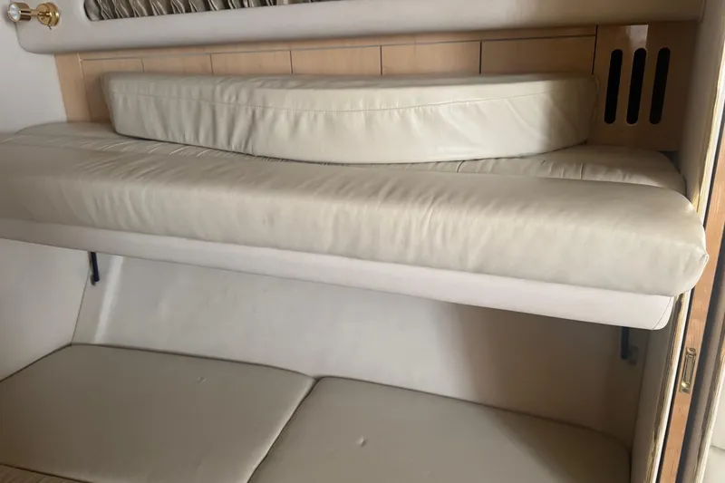 Slide: The Image of Interior seating of 2001 Sea Ray 410 Sundancer with beige cushions. - 21