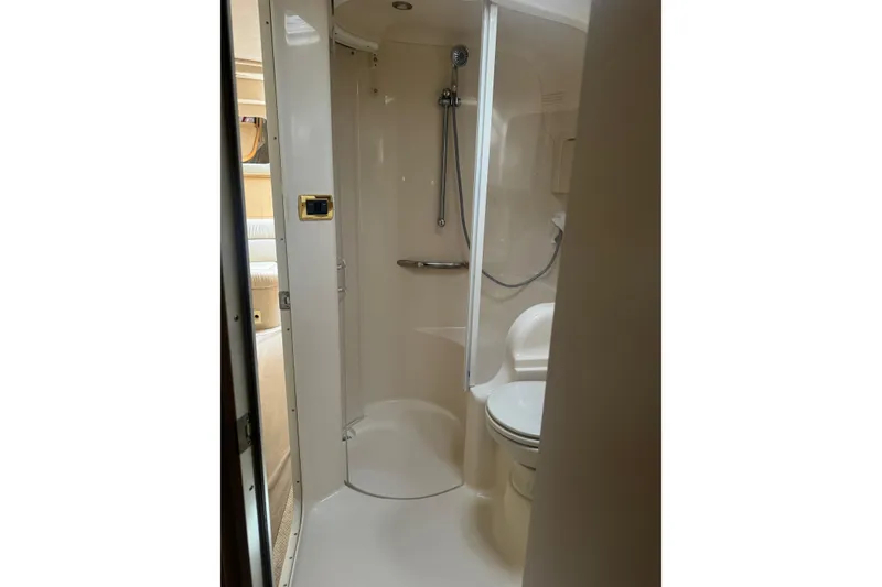 Slide: The Image of Bathroom interior of 2001 Sea Ray 410 Sundancer yacht, featuring shower and toilet. - 27
