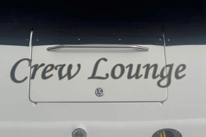 Slide: The Image of 2001 Sea Ray 410 Sundancer boat with "Crew Lounge" text on the stern. - 4