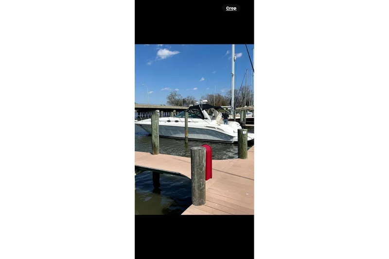 Slide: The Image of 2001 Sea Ray 410 Sundancer docked at marina under clear blue sky. - 9