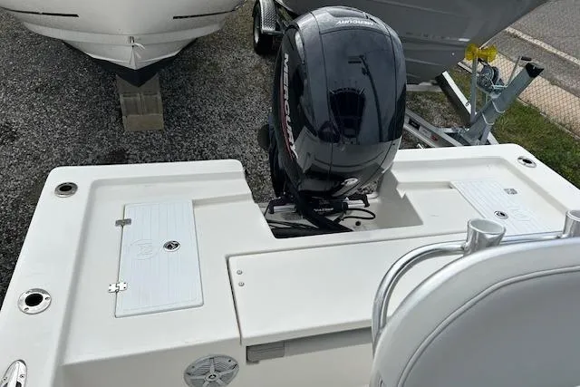 Slide: The Image of 2023 May-Craft 22 Handcock boat with Mercury outboard motor, parked on gravel. - 5