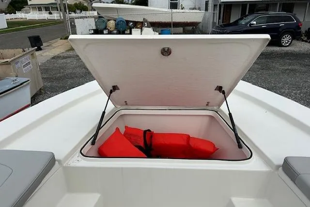 Slide: The Image of 2023 May-Craft 22 Handcock boat storage compartment with red life jackets. - 8