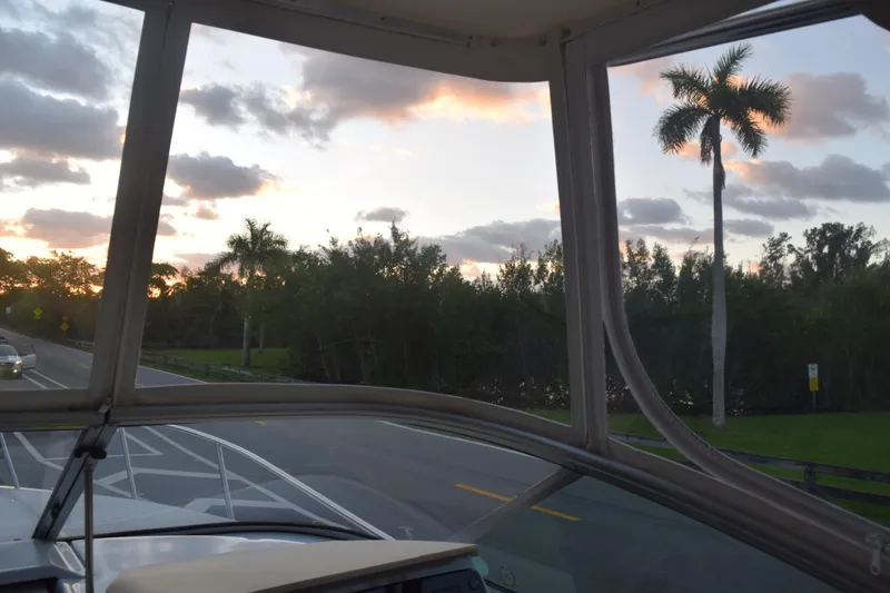 Slide: The Image of 2021 Regal 26 XO boat on road at sunset with palm trees. - 100