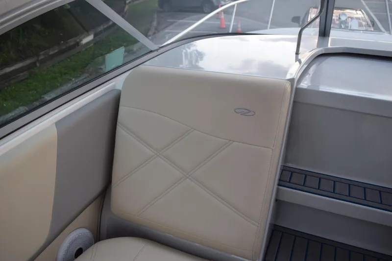Slide: The Image of 2021 Regal 26 XO boat interior with beige seating and speaker detail. - 102