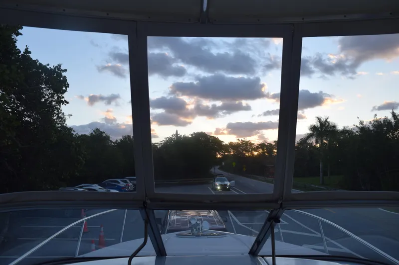 Slide: The Image of View from a 2021 Regal 26 XO boat at sunset, parked near a road. - 103