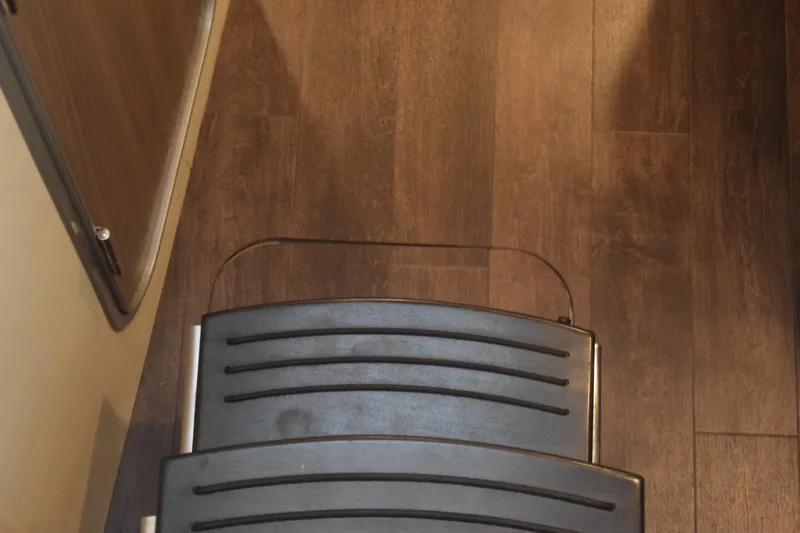 Slide: The Image of Interior view of 2021 Regal 26 XO boat with wooden flooring and a foldable step. - 108