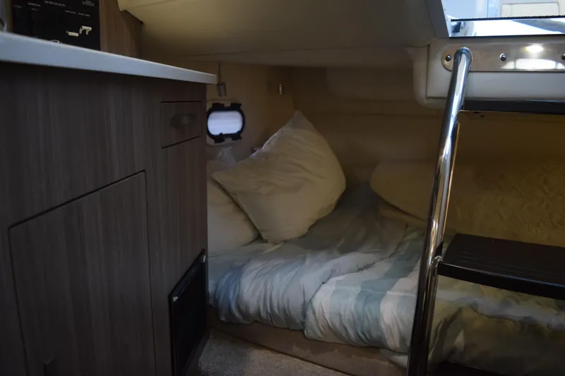 Slide: The Image of Cozy cabin interior of 2021 Regal 26 XO boat with bed and ladder. - 112