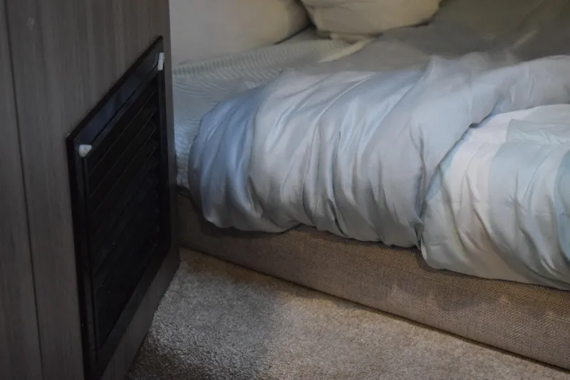 Slide: The Image of Cozy bed inside 2021 Regal 26 XO boat cabin with soft bedding. - 113