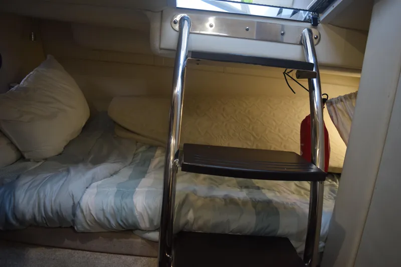 Slide: The Image of 2021 Regal 26 XO cabin interior with bed and ladder. - 114
