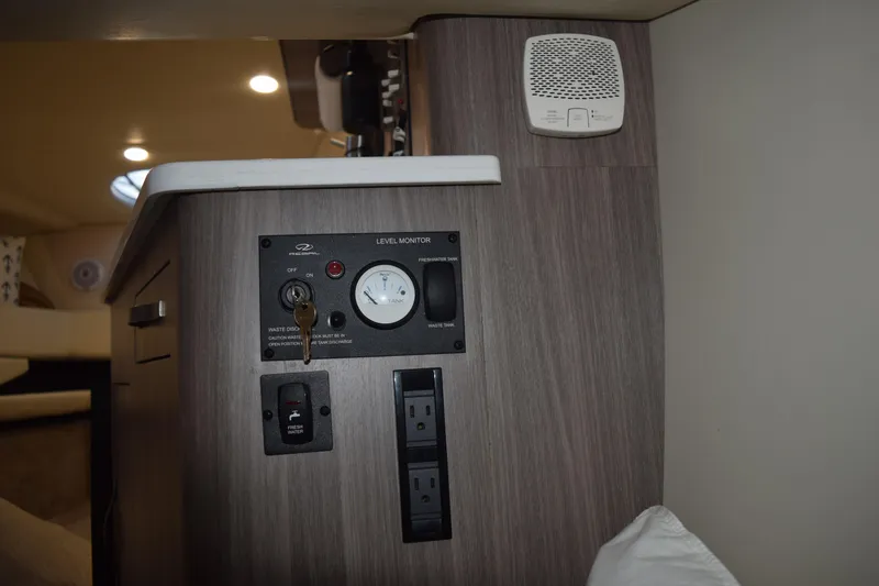 Slide: The Image of 2021 Regal 26 XO boat interior showing control panel and outlets. - 117