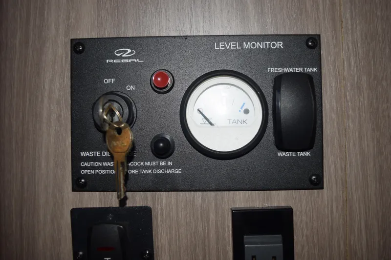 Slide: The Image of Control panel of a 2021 Regal 26 XO boat with level monitor and key. - 119