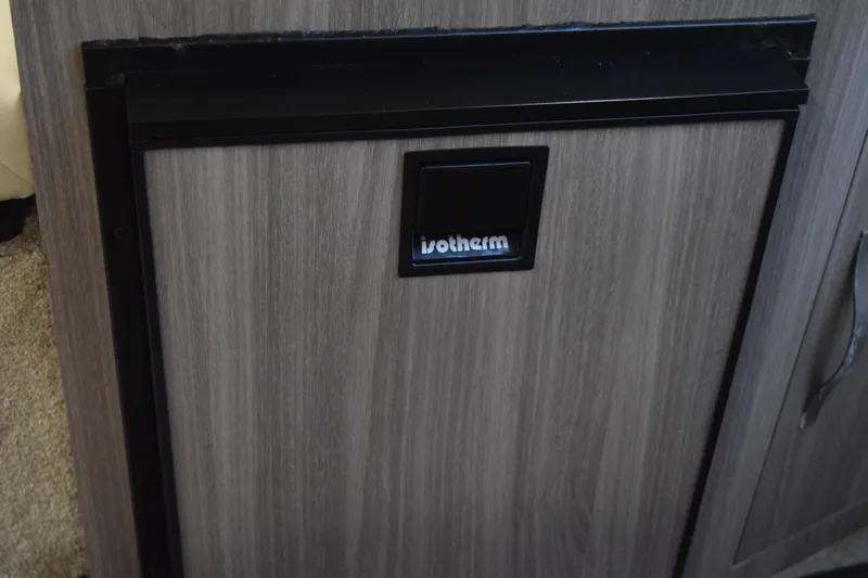 Slide: The Image of Wooden cabinet with a built-in Vitrifrigo fridge on a 2021 Regal 26 XO boat. - 127
