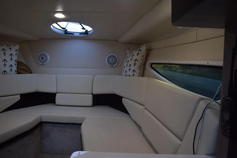 Slide: The Image of Luxurious interior of 2021 Regal 26 XO boat with plush seating and porthole window. - 135