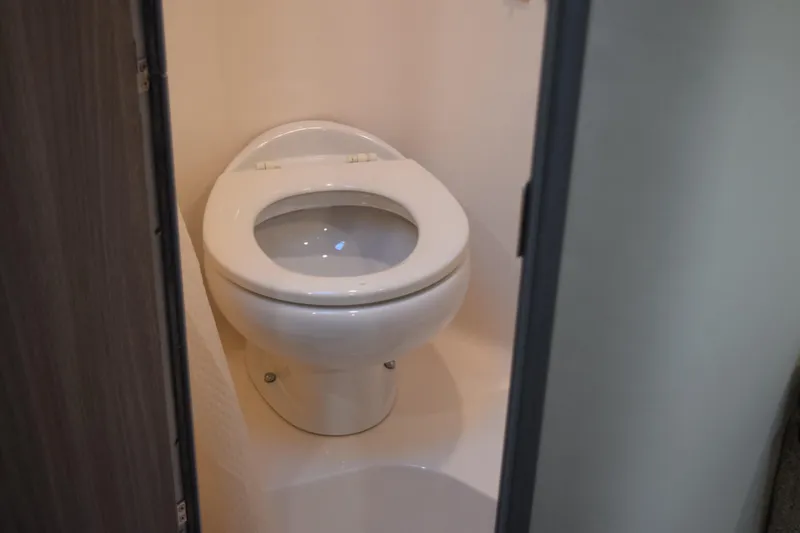 Slide: The Image of 2021 Regal 26 XO boat interior bathroom with white toilet. - 145