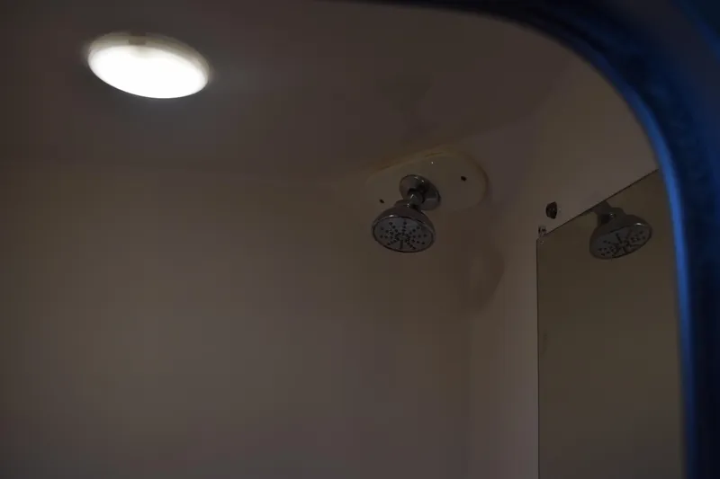 Slide: The Image of Shower area inside 2021 Regal 26 XO boat, featuring modern fixtures and lighting. - 147