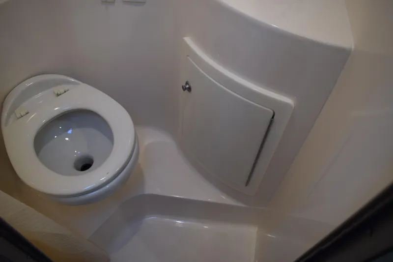 Slide: The Image of 2021 Regal 26 XO boat bathroom with compact toilet and storage compartment. - 149