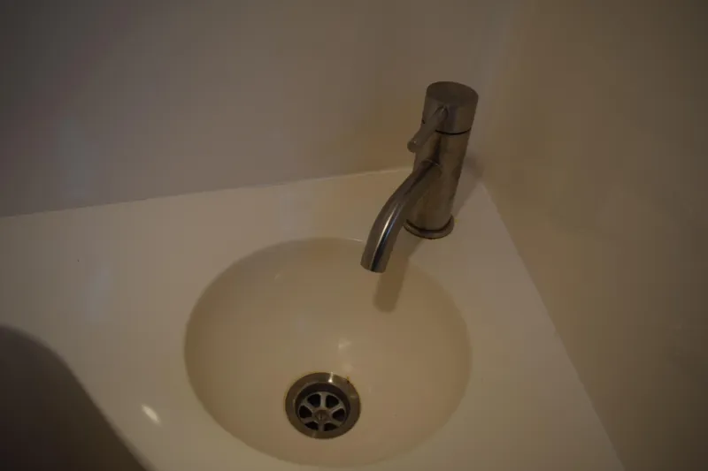Slide: The Image of Stainless steel faucet and sink in 2021 Regal 26 XO boat bathroom. - 153