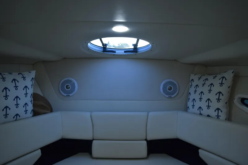 Slide: The Image of 2021 Regal 26 XO cabin interior with anchor-themed pillows and round speakers. - 154
