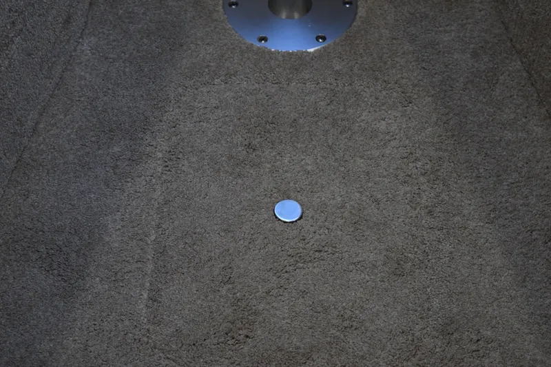 Slide: The Image of Carpeted floor of a 2021 Regal 26 XO boat with a metal fixture. - 157