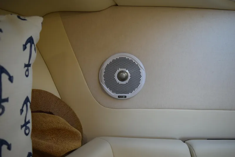 Slide: The Image of Interior of 2021 Regal 26 XO boat with Fusion speaker and anchor-patterned pillow. - 165