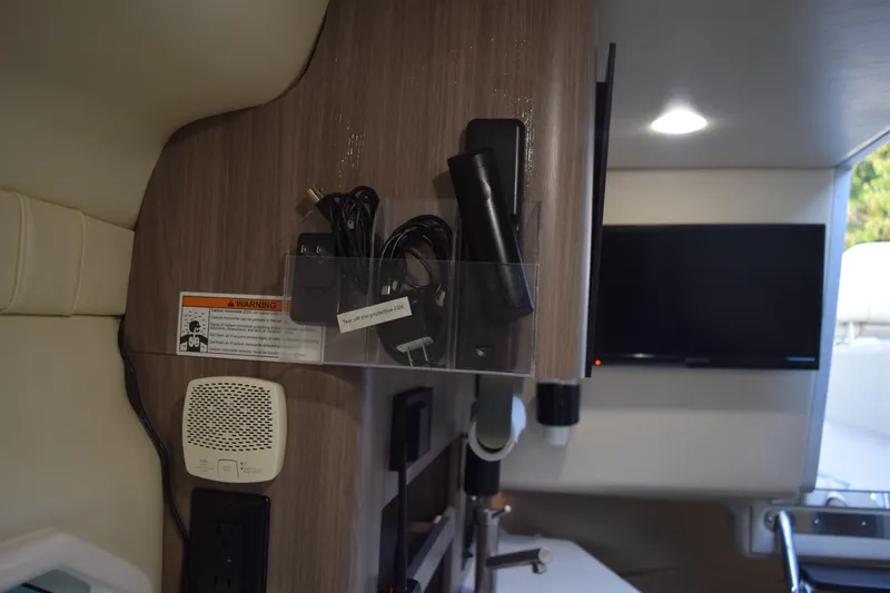 Slide: The Image of Interior of 2021 Regal 26 XO boat with TV, speaker, and storage area. - 166