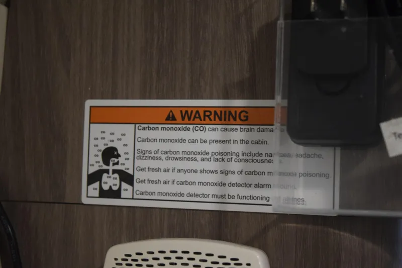 Slide: The Image of Warning label about carbon monoxide safety on a 2021 Regal 26 XO boat. - 167