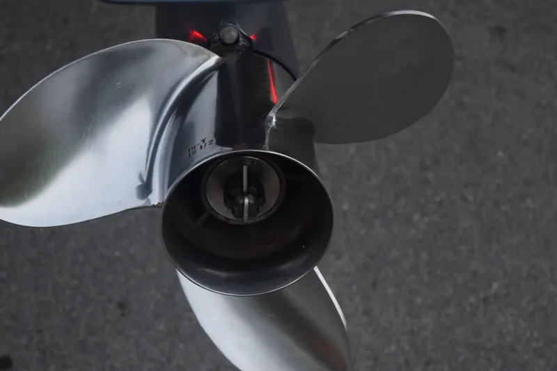 Slide: The Image of Close-up of a 2021 Regal 26 XO boat propeller on a dark background. - 17
