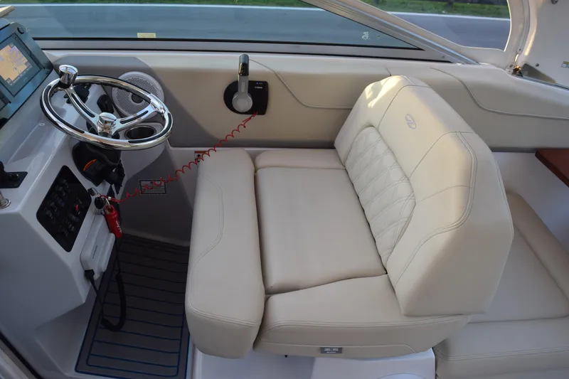 Slide: The Image of 2021 Regal 26 XO boat interior with steering wheel and beige seating. - 172