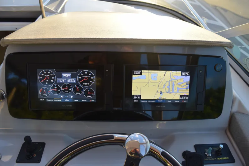 Slide: The Image of Dashboard of a 2021 Regal 26 XO boat with Garmin navigation displays. - 173