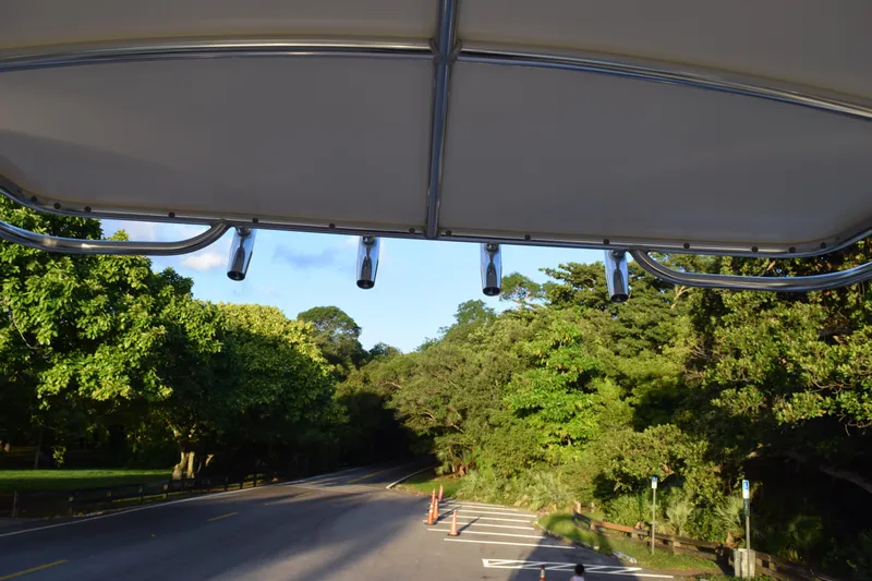 Slide: The Image of 2021 Regal 26 XO boat canopy with scenic forest road view. - 182