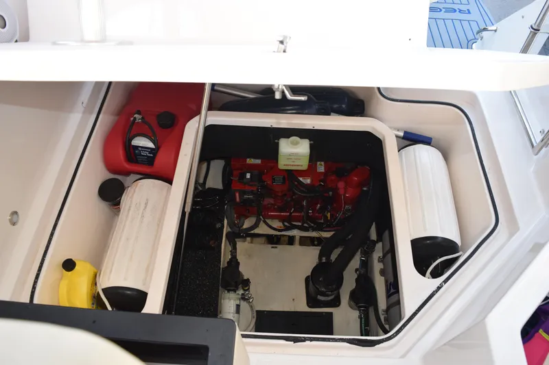 Slide: The Image of Engine compartment of 2021 Regal 26 XO boat with visible components and storage. - 187