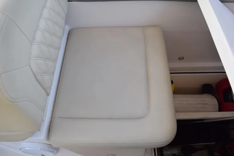 Slide: The Image of 2021 Regal 26 XO boat seat with storage compartment open. - 188